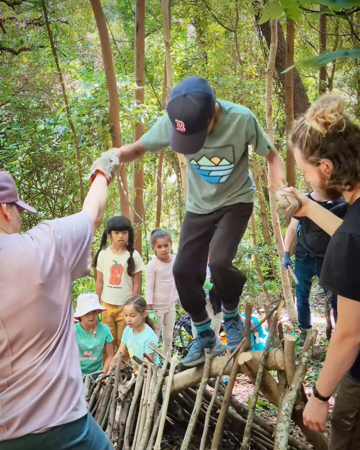 Wilderness Skills Community Day children and families playing in nature